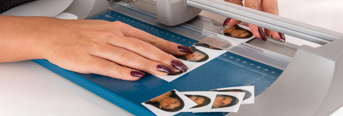 Woman cutting and sizing passport photos