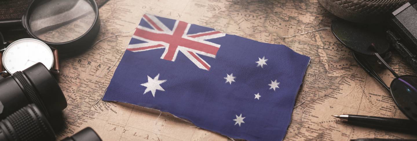 Australia flag between traveler's accessories on old vintage map. tourist destination concept. 
