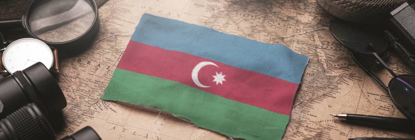 Azerbaijan flag between traveler's accessories on old vintage map. tourist destination concept.
